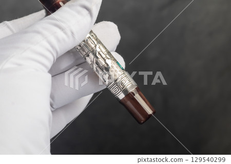 Branded fountain pen on marble gray background. Gift set. Office interior. 129540299