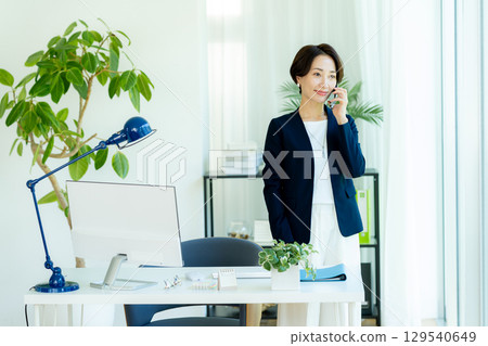 Business woman using a smartphone in the office 129540649