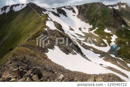 pass with a steep slope and a lake in the valley pass with a steep slope and a lake in the valley 129540722