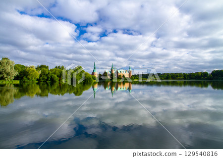 Frederiksborg Castle and its reflection on Lake Pallassee in Hillerød, near Copenhagen, in the Nordic Kingdom of Denmark 129540816