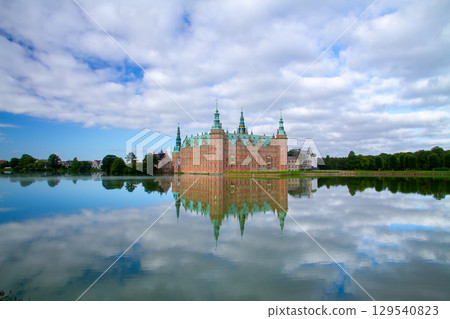 Frederiksborg Castle and its reflection on Lake Pallassee in Hillerød, near Copenhagen, in the Nordic Kingdom of Denmark 129540823