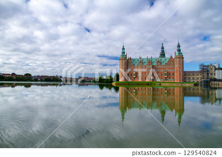 Frederiksborg Castle and its reflection on Lake Pallassee in Hillerød, near Copenhagen, in the Nordic Kingdom of Denmark 129540824