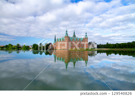 Frederiksborg Castle and its reflection on Lake Pallassee in Hillerød, near Copenhagen, in the Nordic Kingdom of Denmark 129540826
