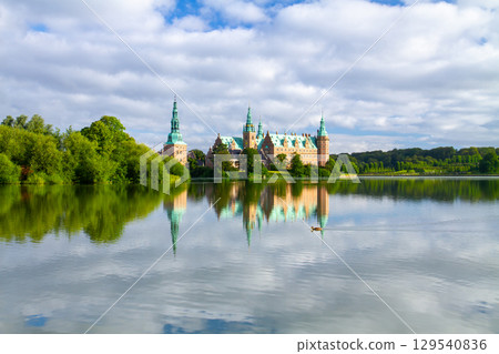 Frederiksborg Castle and its reflection on Lake Pallassee in Hillerød, near Copenhagen, in the Nordic Kingdom of Denmark 129540836