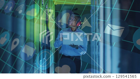 Image of data processing over male african american server room worker using headphones 129541565