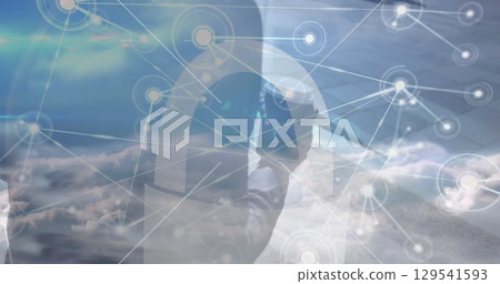 Image of network of connections over clouds and midsection of africanamerican businessman 129541593