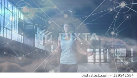 Image of network of connections over clouds and fit afrcian american woman jumping Image of network of connections over clouds and fit afrcian american woman jumping 129541594