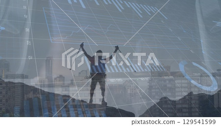 Image of financial graphs and data over man in mountains 129541599