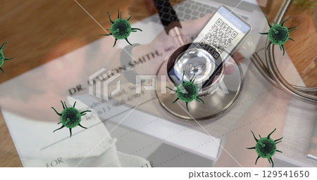 Image of green cells over stethoscope, documents and man with smartphone with covid passport Image of green cells over stethoscope, documents and man with smartphone with covid passport 129541650