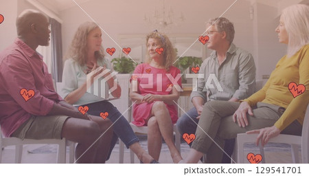 Image of falling hearts over group of diverse seniors 129541701