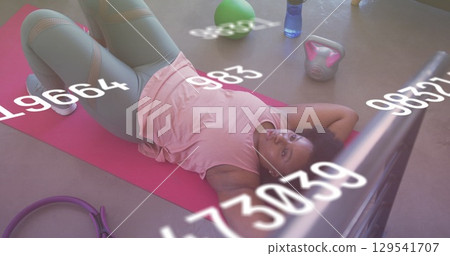 Image of falling numbers over afican american women practicing Image of falling numbers over afican american women practicing 129541707