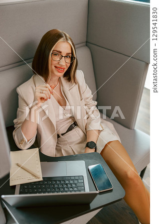 An Elegant and Stylish Businesswoman Working in a Modern and Trendy Office Environment 129541830