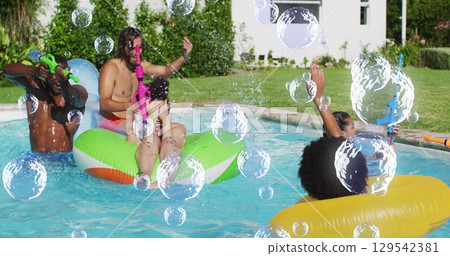 Image of bubbles over happy diverse friends having fun in swimming pool Image of bubbles over happy diverse friends having fun in swimming pool 129542381
