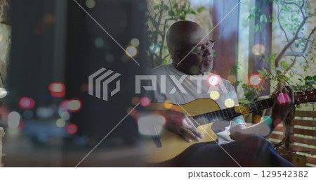 Image of glowing lights over senior african men playing guitar Image of glowing lights over senior african men playing guitar 129542382