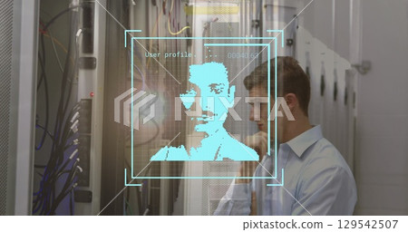 Standing man studying holographic profile in data center, with server racks, cables, copy space Standing man studying holographic profile in data center, with server racks, cables, copy space 129542507