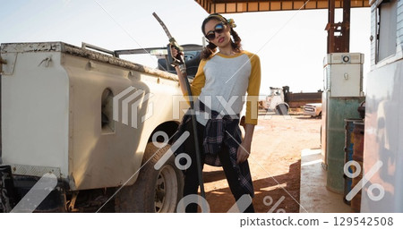 Image of percent sing over women refueling car Image of percent sing over women refueling car 129542508
