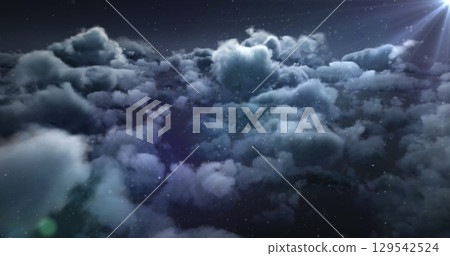 Image of clouds and dots moving over dark sky 129542524