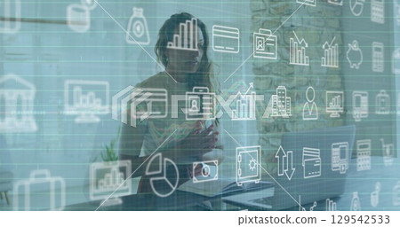 Image of financial icons over caucasian woman having image call on laptop 129542533