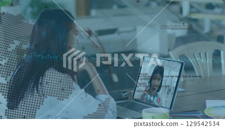 Image of graphs, globe and data over woman having image call on laptop 129542534