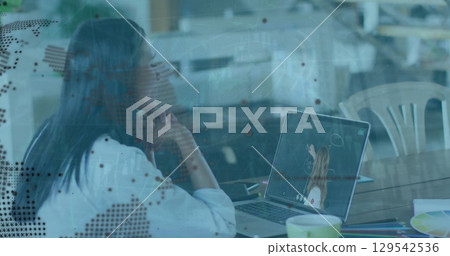 Image of data processing and globe over businesswoman using laptop Image of data processing and globe over businesswoman using laptop 129542536