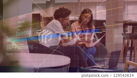 Image of deleting files over diverse female and male coworkers in office 129542614