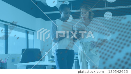 Image of graphs and globe over diverse female coworkers in office 129542623