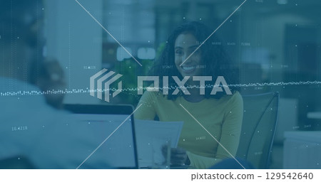 Image of graphs over woman with laptop in office 129542640