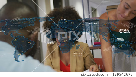Image of world map over diverse business people in office Image of world map over diverse business people in office 129542673