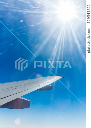 View on sunset and airplane wing from the inside 129543821