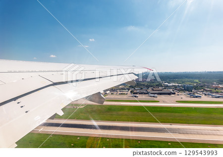 View from the airplane window during takeoff at Sheremetyevo airport at summer View from the airplane window during takeoff at Sheremetyevo airport at summer 129543993