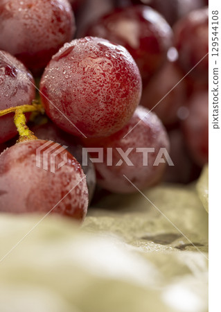 wet grapes on the table closeup, clean wet grapes safe for eating, close up 129544108