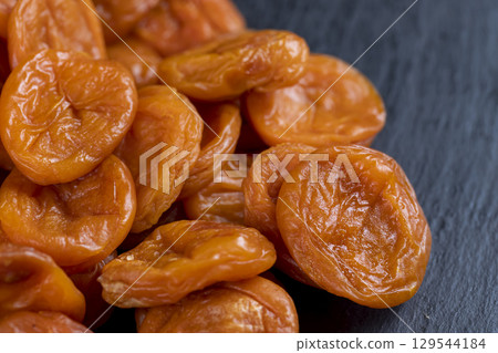 dried apricots from small apricots are orange in color, dehydrated in the sun and without seeds, closeup dried apricots from small apricots are orange in color, dehydrated in the sun and without seeds, closeup 129544184