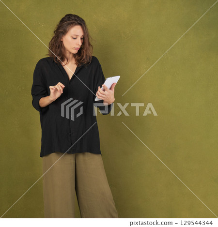 Contemplative Woman Holding Smartphone 129544344
