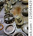 Gears and parts of an automobile automatic transmission on a metal table 129544429