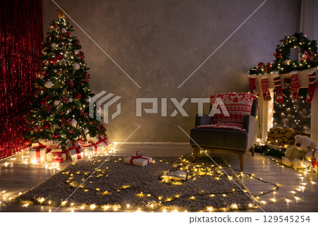 Interior with Christmas tree decorated with gifts, lights, garlands for the new year 129545254