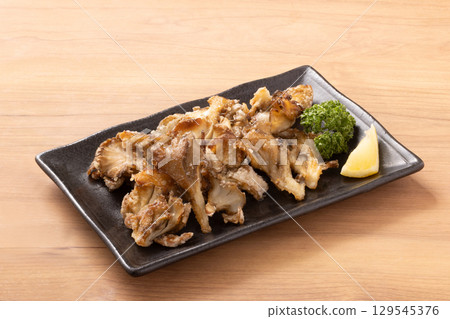 Maitake mushrooms grilled with butter and soy sauce 129545376