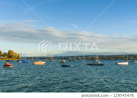 Anchored boats along the shoreline in Allensbach, Lake Constance, Baden-Wuerttemberg, Germany 129545476