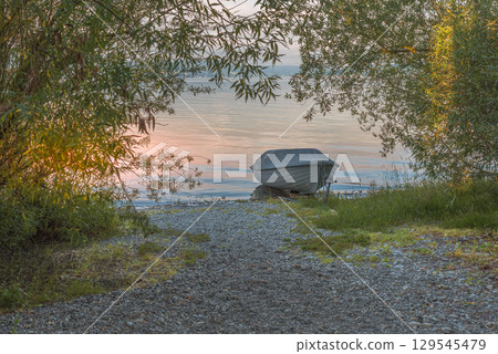 Covered rowboat on the shore of Reichenau Island, Lake Constance, Baden-Wuerttemberg, Germany 129545479