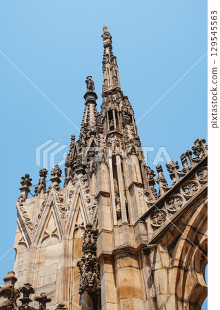 gothic spires and statues of the Duomo di Milano gothic spires and statues of the Duomo di Milano 129545563