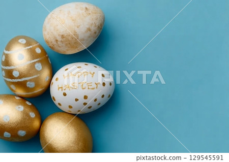 Easter background. Easter golden decorated eggs on blue background. Minimal easter concept. Flat Lay of Golden Easter Eggs Easter background. Easter golden decorated eggs on blue background. Minimal easter concept. Flat Lay of Golden Easter Eggs 129545591