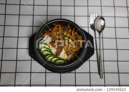 Stir Tried Pork Belly With Korean Sauce Over Rice, Background for advertising and wallpaper in culture and food scene. Stir Tried Pork Belly With Korean Sauce Over Rice, Background for advertising and wallpaper in culture and food scene. 129545622