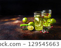 Lime Lemonade with thyme, cranberry and ice. 129545663