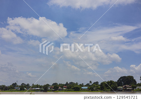 Atmosphere Along The Chao Phraya River On Clear Day In Chai Nat Province. Taken on a bright, clear day in Chai Nat Province, this image features the river's gentle flow. Perfect for travel promotions 129545721