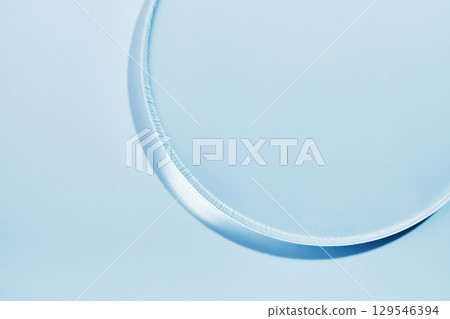 Empty round petri dish or glass slide close-up on light blue background. Mockup for cosmetic product sample Empty round petri dish or glass slide close-up on light blue background. Mockup for cosmetic product sample 129546394