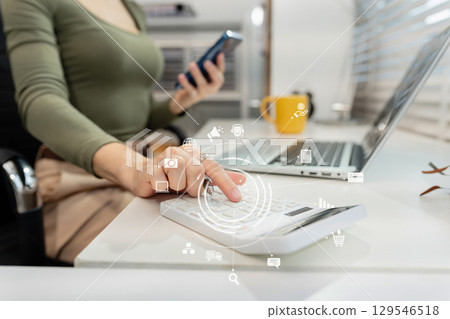 Hand women doing finances and calculate on desk about cost at home office. Hand women doing finances and calculate on desk about cost at home office. 129546518