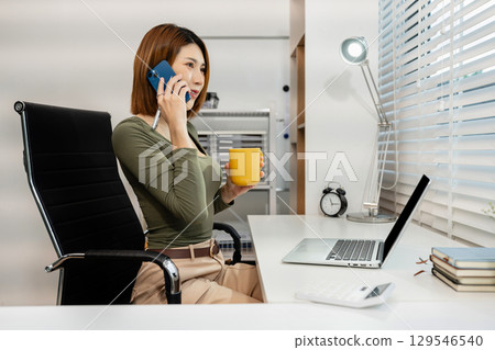 women talk mobile phones update tasks with milestones progress planning while working on laptop computers, online business, teleworking concept. 129546540