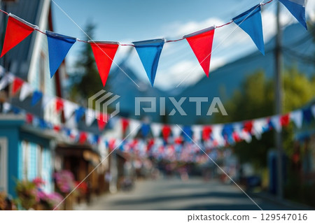 Flag garlands on the city street in honor of the city day celebration. Alaska Day. Blue, red and white garland colors. Flag garlands on the city street in honor of the city day celebration. Alaska Day. Blue, red and white garland colors. 129547016