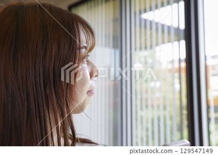 一位女士凝視著窗外的側影 129547149