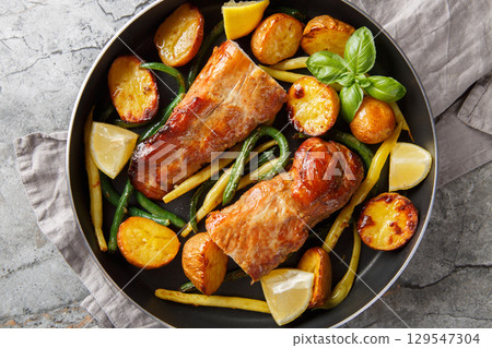 Lemon Garlic Pork Roast with french beans and new Potatoes close-up in a pan. Horizontal top view Lemon Garlic Pork Roast with french beans and new Potatoes close-up in a pan. Horizontal top view 129547304