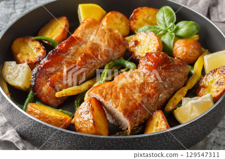 Baked Lemon garlic Pork Tenderloin with french beans and new Potatoes close-up in a pan. Horizontal 129547311